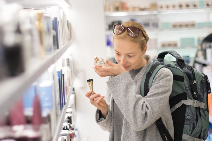 Female traveller shopping for perfume at duty-free store